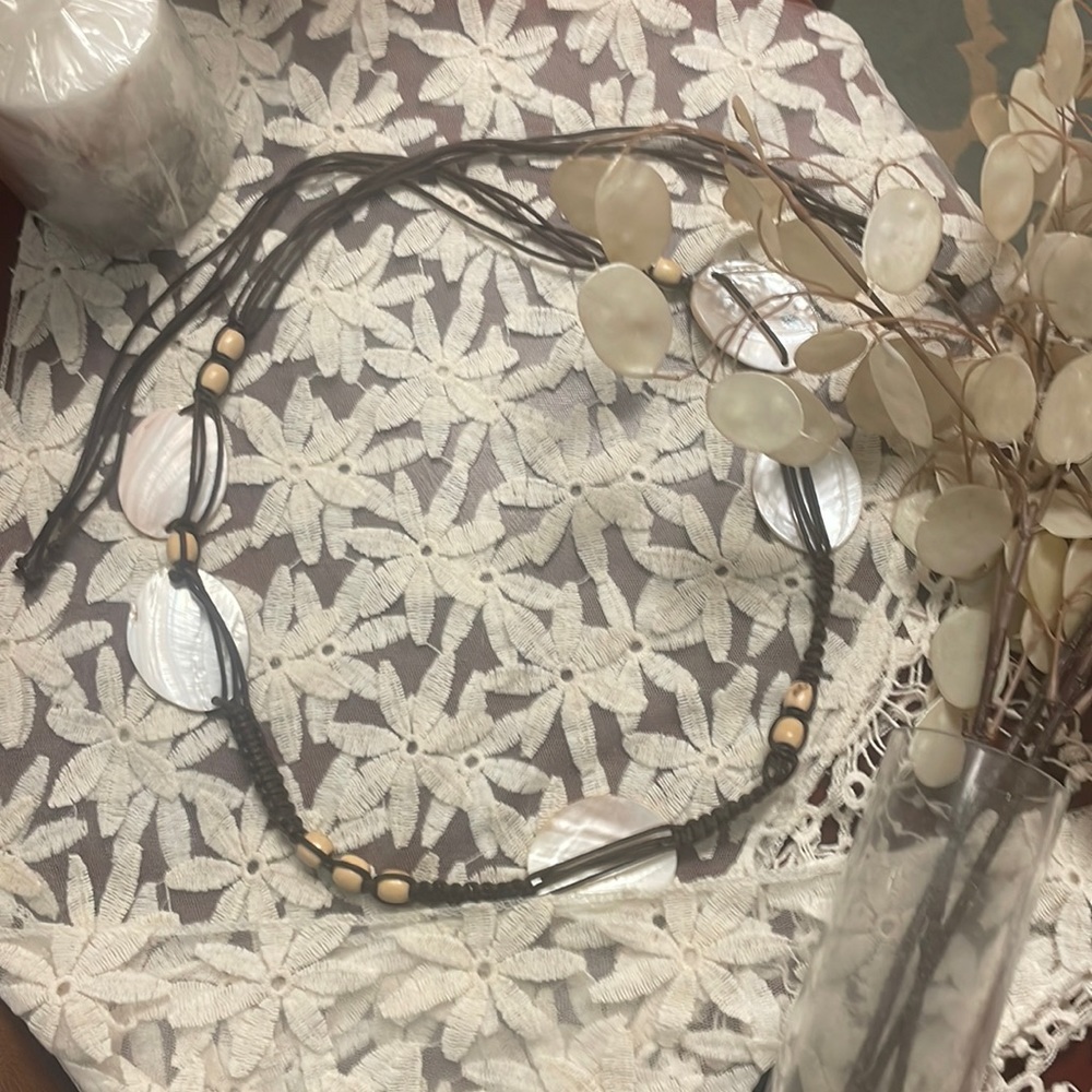 Seashell, wood bead, and brown twine necklace. Perfect condition, looks amazing.